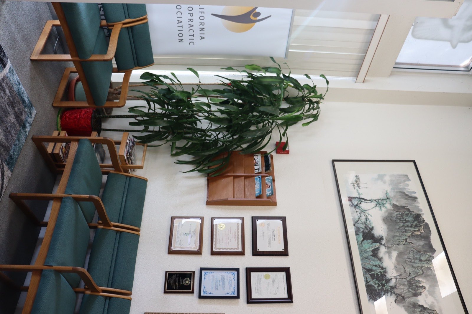 The waiting room, with the certificate wall behind the seating
